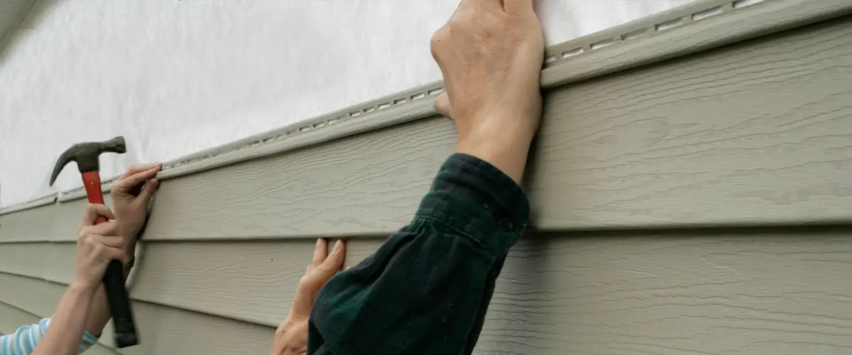 Professional vinyl siding installation on a residential home exterior, ensuring durability and curb appeal.