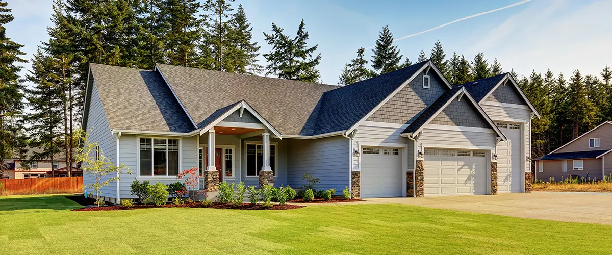 Modern suburban home with gray siding and manicured lawn